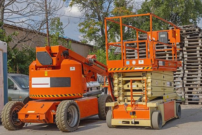 forklift transporting goods in a busy warehouse setting in Greenacres, FL